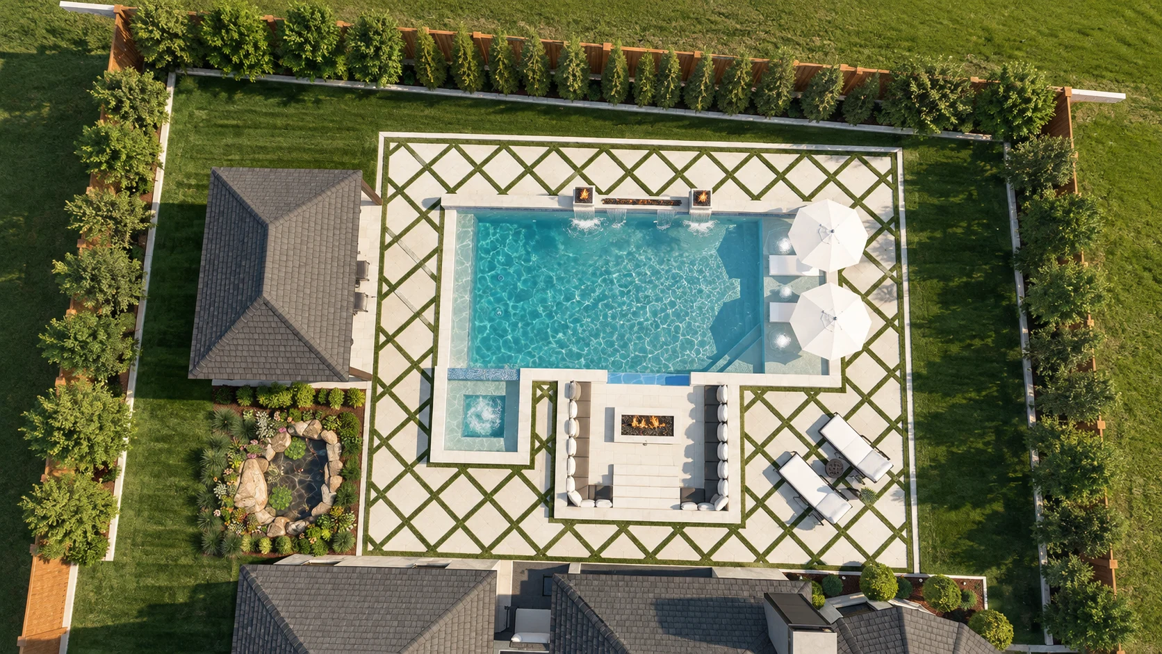 Aerial view of the backyard pool, spa, and sunken fire lounge